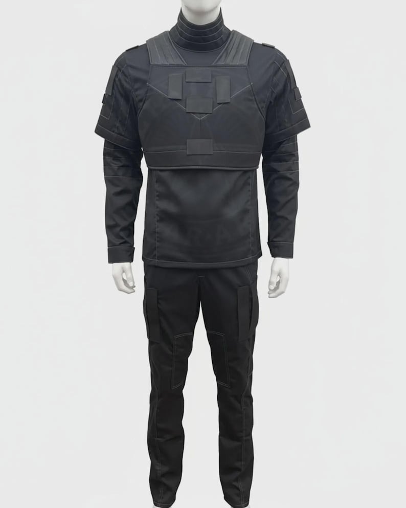 May include: A black tactical uniform displayed on a mannequin. The outfit includes a long-sleeved shirt with a high collar, a chest plate, and cargo pants. The uniform is designed with multiple pockets and reinforced panels.