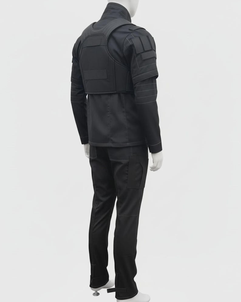 May include: Black tactical outfit, including a jacket with a vest, long-sleeve shirt, and cargo pants. The jacket has multiple pockets and reinforced panels. The pants have pockets on the sides. The outfit is displayed on a mannequin.