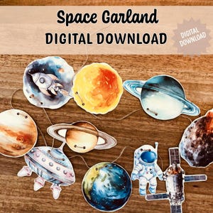 May include: A space-themed garland with watercolour illustrations of planets, a rocket, an astronaut, and a satellite. The garland includes the text "Space Garland DIGITAL DOWNLOAD". The planets are in shades of blue, orange, and brown.