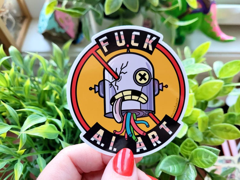 Puede incluir: Una pegatina redonda con un dise&ntilde;o de robot. El robot tiene la cabeza agrietada, una lengua fuera y cables coloridos. La pegatina tiene el texto "FUCK A.I. ART" en un c&iacute;rculo rojo con una l&iacute;nea que lo cruza.