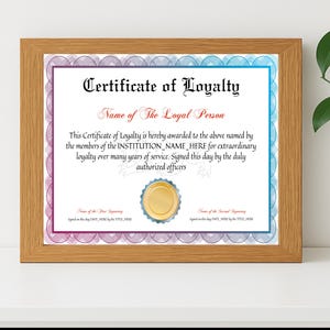 May include: A framed certificate of loyalty with a wooden frame. The certificate has a white background with a blue and purple border. The text reads "Certificate of Loyalty" and "Name of The Loyal Person".
