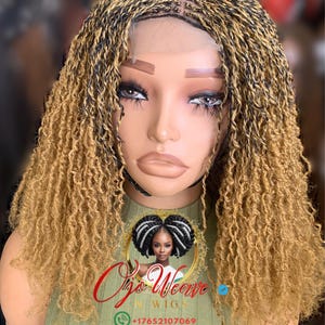 May include: A mannequin head displaying a braided wig with a curly, light brown texture. The wig features a lace front and a mix of black and blonde braids. The Ojo Weave logo is visible on the mannequin's chest.