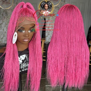 May include: A vibrant pink braided wig with a lace front. The wig is styled in a half-up, half-down ponytail. The image also shows the text "Weave N Wig" on a black shirt.