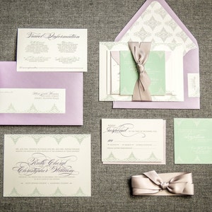 May include: Wedding invitation suite with a green and purple color scheme. The invitation features a delicate floral design and the names "Ruth Cheryl" and "Christopher William". The RSVP card includes a response line and a space for guests to write their names.