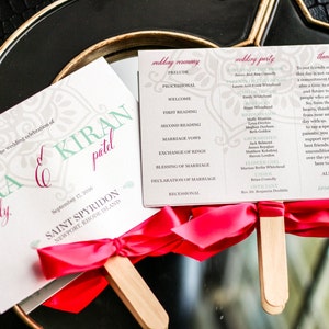 May include: Wedding ceremony program fans with a pink ribbon and wooden stick. The program includes the wedding ceremony schedule, wedding party names, and a thank you message to guests. The front of the fan features the names "Mira Kiran Reddy" and the date "September 12, 2016".