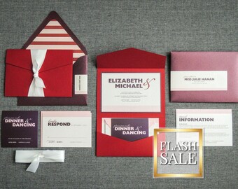 May include: Red, burgundy, and pink wedding invitation suite with a white ribbon and the text "Elizabeth & Michael" and "Dinner & Dancing".