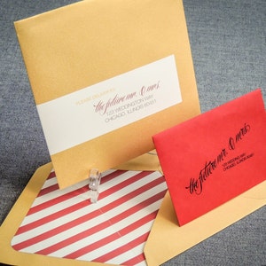 May include: Two envelopes with red and white striped paper inside. The envelopes are addressed to "the future mr. & mrs." with a street address and city, state, and zip code.