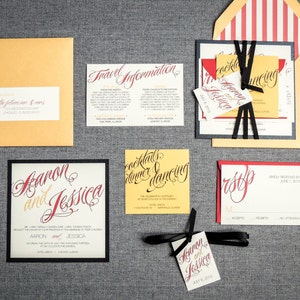May include: Wedding invitation suite with a yellow, red, and black color scheme. The invitation features the names "Aaron and Jessica" in elegant calligraphy. The RSVP card is red with black calligraphy. The travel information card is yellow with black calligraphy.
