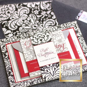 May include: Black and white damask patterned wedding invitation with red accents. The invitation includes the names "Ruth and Christopher" and the date "October 29, 2012".