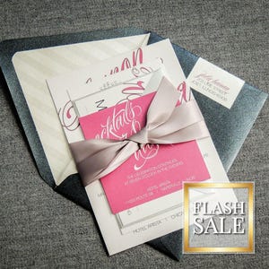 May include: A pink and white wedding invitation with a gray satin ribbon. The invitation features the text "Cocktails & More" in a pink script font. The invitation also includes the text "The celebration continues at seven o'clock in the evening" and the address "Hotel Arista, 1000 Route 18,  Teterboro, NJ".