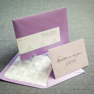 May include: Two purple envelopes with white and green floral designs. The top envelope has the text "The future is, and yours." and the address "111 Wedding Way, Chicago, Illinois 60411". The bottom envelope has the text "Please address to" and the address "111 Live Street, Joliet, Illinois 60431".