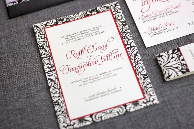 May include: A wedding invitation with a black and white damask pattern border and red trim. The invitation reads "MR. AND MRS. STEPHEN MUTTRAM & MR. AND MRS. DENNIS HOCKER request the honor of your presence AT THE MARRIAGE OF THEIR CHILDREN Ruth Cheryl and Christopher William SATURDAY THE TWENTY NINTH OF OCTOBER TWO THOUSAND TWELVE AT FIVE THIRTY IN THE EVENING saint dennis church OAKBROOK TERRACE, ILLINOIS"