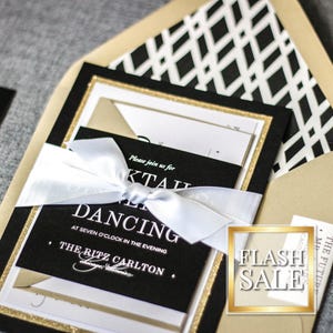 a black and gold wedding suite with a white ribbon