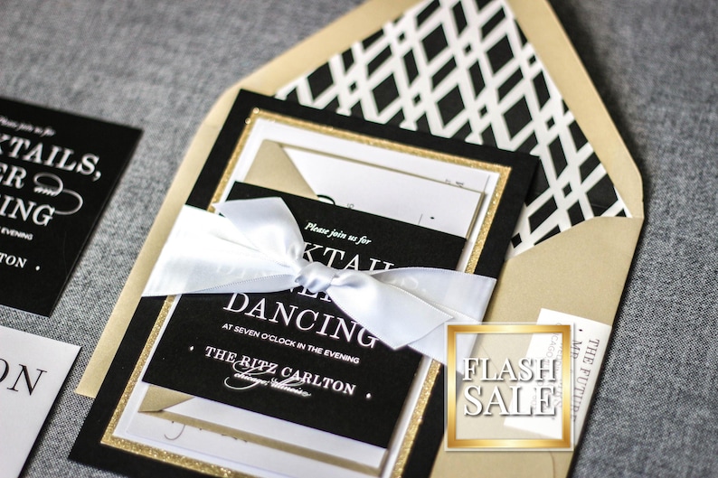 a black and gold wedding suite with a white ribbon