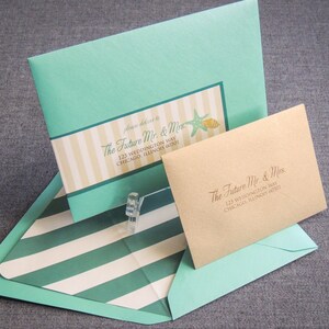 May include: A light blue envelope with a white and yellow striped design and the text "The Future Mr. & Mrs. 123 Weddington Way Chicago, Illinois 60601" is inside a larger light blue envelope with a white and green striped design. A smaller brown envelope with the text "The Future Mr. & Mrs. 123 Weddington Way Chicago, Illinois 60601" is inside the larger envelope.