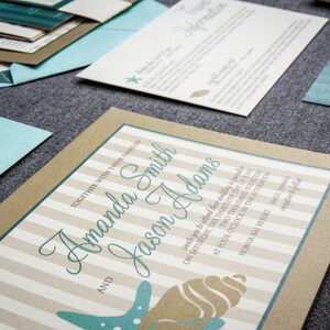 May include: A wedding invitation with a brown and white striped background. The invitation features a seashell and starfish design with the text "Amanda Smith and Jason Adams" in teal blue script.