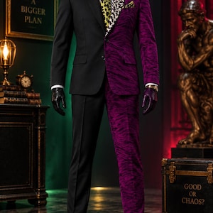 May include: A two-tone suit featuring a solid black side and a purple side with a textured animal-like pattern. The ensemble includes a white dress shirt, a yellow and black leopard print tie, a matching pocket square, and black leather gloves.
