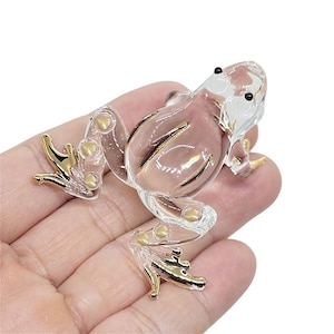 May include: A handmade wooden sign with the text "Welcome" in a playful font. The sign is painted white with a distressed finish, and features a decorative floral design in shades of pink and green. It measures approximately 12 inches wide.