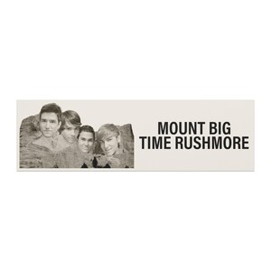May include: A rectangular sign with a sepia-toned image of four men's faces superimposed on a mountain range. The text "MOUNT BIG TIME RUSHMORE" is printed in black, sans-serif font on the right side of the sign.