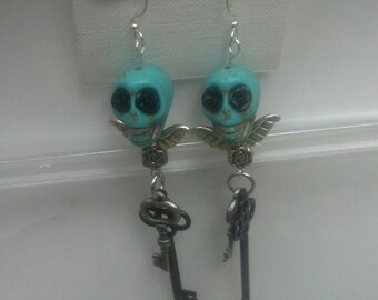 Turquoise light blue with black flower eyes howlite bead with wings and keys dangle earring