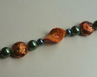 Funky orange textured beads mixed with silver and green pearl handmade bracelet with lg lobster claw clasp