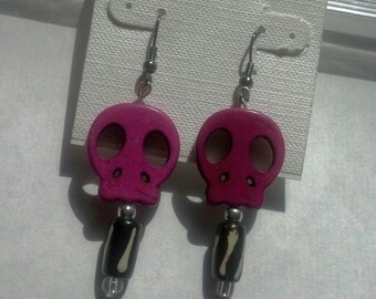 Purple skull sitting on black and white swirl bead wire dangle handmade earring