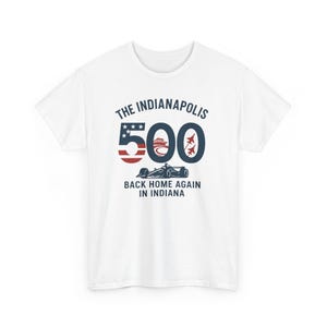 May include: White t-shirt featuring the text "The Indianapolis 500" in navy blue, with a red and white striped "500" graphic. Below the graphic is a race car and the text "Back Home Again in Indiana."