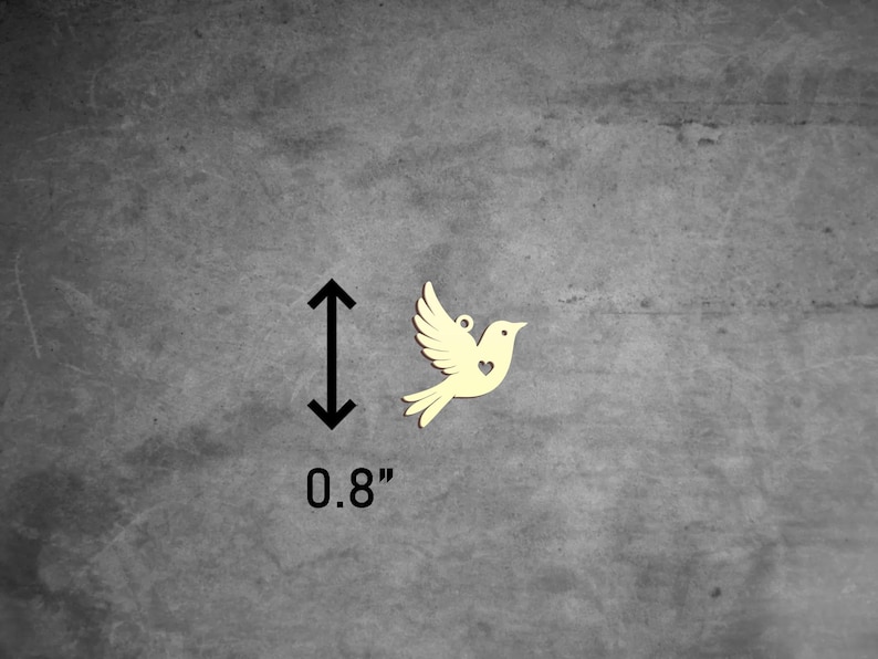 Puede incluir: Una peque&ntilde;a paloma de madera amarilla con un coraz&oacute;n recortado en el pecho. La paloma mide 0,8 pulgadas de alto.