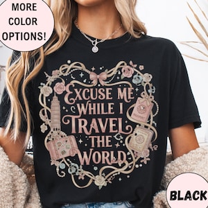 Vintage-inspired pink and beige travel-themed shirt with passport, suitcase, and the quote “Excuse Me While I Travel The World” framed in florals.
