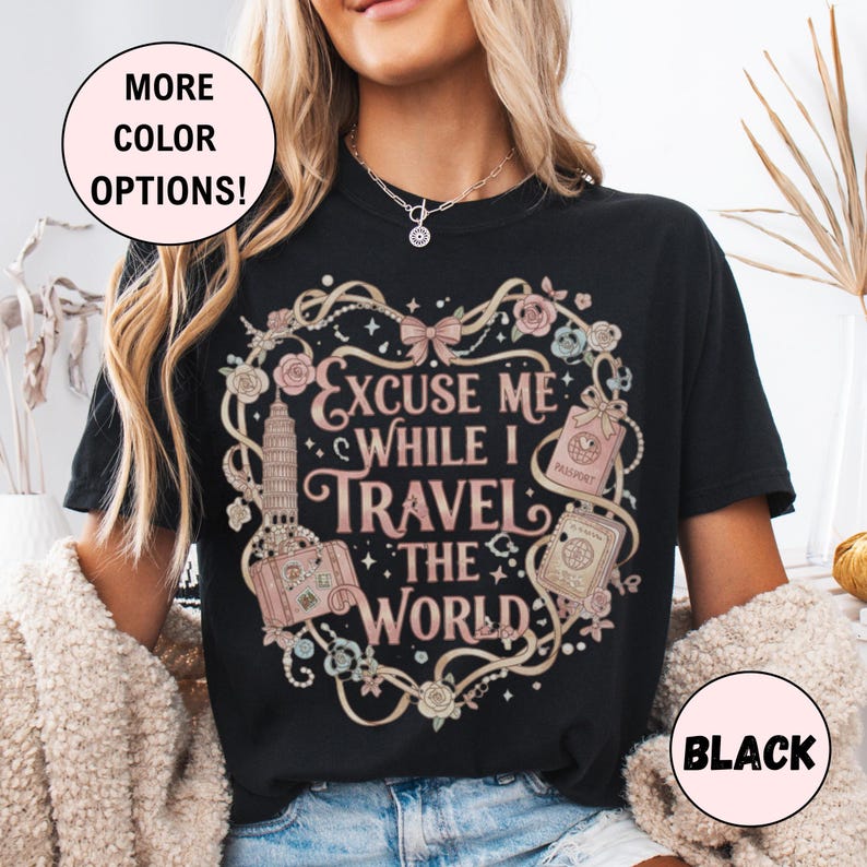 Vintage-inspired pink and beige travel-themed shirt with passport, suitcase, and the quote “Excuse Me While I Travel The World” framed in florals.