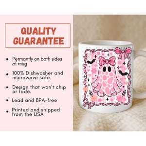 ceramic coffee mug featuring a pink spotted ghost with a bow, surrounded by bats, hearts, and flowers in a coquette aesthetic design