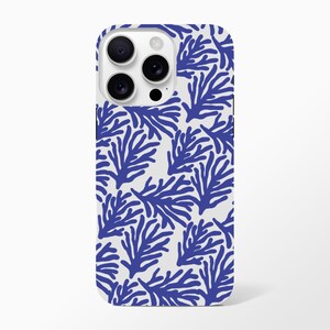 May include: A white phone case with a repeating pattern of blue, coral-like shapes. The case has a glossy finish and a camera cutout with three lenses and a flash. The design is modern and evokes a coastal theme.