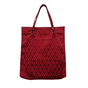 May include: A red tote bag with a repeating geometric pattern. The bag has two handles and a rectangular shape. The handles are a darker shade of red than the body of the bag. The bag is made of a shiny material.