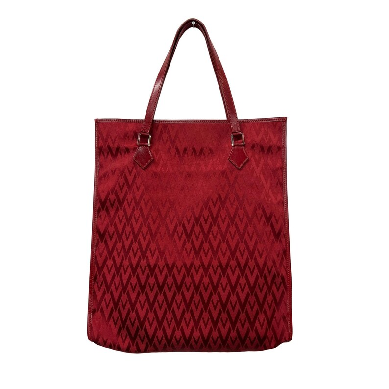 May include: A red tote bag with a repeating geometric pattern. The bag has two handles and a rectangular shape. The handles are a darker shade of red than the body of the bag. The bag is made of a shiny material.