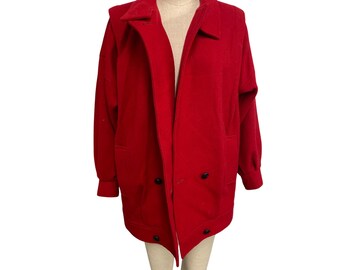 May include: A bright red wool coat with a classic design. The coat features a wide collar, two front pockets, and black buttons. The coat is displayed on a mannequin.