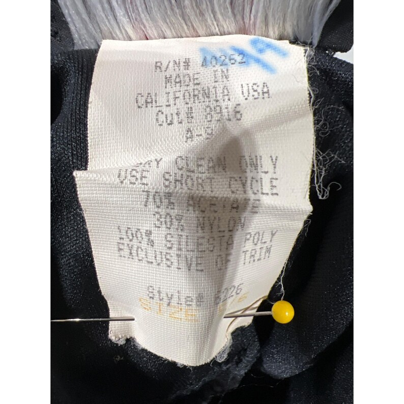 May include: White tag with black text detailing the care instructions for a garment. The tag reads "Dry Clean Only, Use Short Cycle, 70% Acetate, 30% Nylon, 100% Silesta Poly, Exclusive of Trim, Style # 6226".
