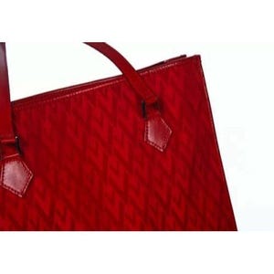 May include: A red tote bag with a geometric pattern. The bag has a glossy finish and features a top handle and decorative leather accents. The bag is designed with a structured shape.