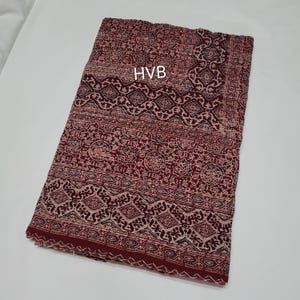 Könnte beinhalten: Ein roter und weißer gemusterter Stoff mit dem aufgedruckten Text "HVB".