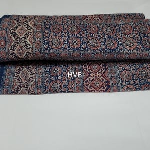 May include: A blue and white patterned fabric with a geometric design. The fabric is folded in half and has a tag that says "HVB" on it.