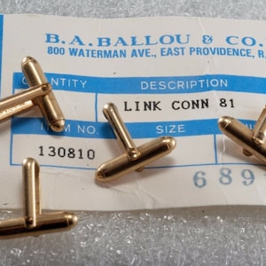 May include: Three gold cufflinks with a blue and white card that reads "B.A. BALLOU & CO. INC. 800 WATERMAN AVE., EAST PROVIDENCE, R.I. 02914" and "LINK CONN 81" with the item number "130810" and "68913".