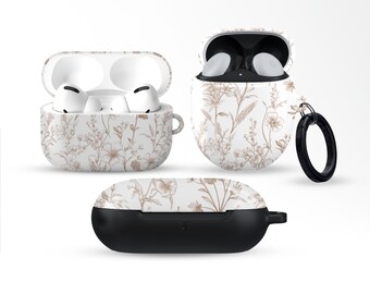 Puede incluir: Se muestran tres fundas para AirPod con un estampado floral blanco y marrón. Una funda está abierta, mostrando auriculares blancos. Otra funda está abierta, con auriculares blancos en su interior. La tercera funda está cerrada, con una base negra.