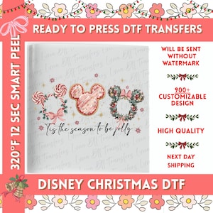 May include: A DTF transfer sheet featuring three Mickey Mouse-shaped icons: one made of peppermint swirls, one with pink frosting, and one with a green holiday wreath. The text 'Tis the season to be jolly' is written in black script below the icons.