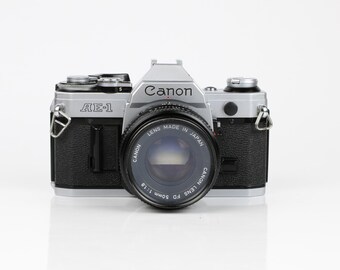 Cámara réflex Canon AE-1 de 35 mm con objetivo Canon FD de 50 mm f/1.8 – Totalmente probada, en excelente estado de funcionamiento.