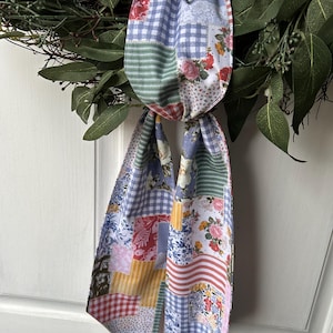 May include: A white ceramic mug with a black handle and the text "But First, Coffee" in a black, bold font. The mug is on a white surface.