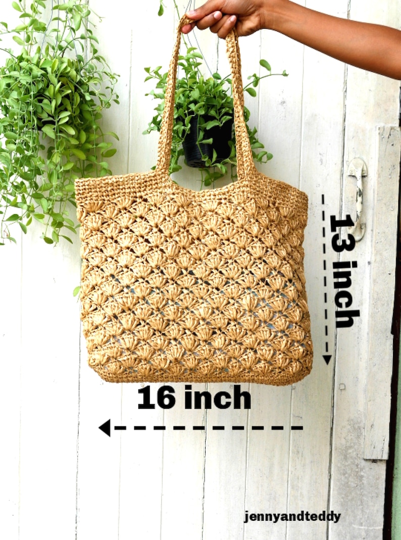 K&ouml;nnte beinhalten: Eine gro&szlig;e, beige, geh&auml;kelte Tragetasche mit einer Breite von 16 Zoll und einer H&ouml;he von 13 Zoll. Die Tasche ist aus Naturfaser und hat eine gewebte Textur.