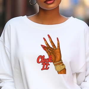May include: White sweatshirt featuring a graphic of a hand with long red fingernails, a gold watch, and the text "Clock It" in red. The hand is making an "okay" gesture.