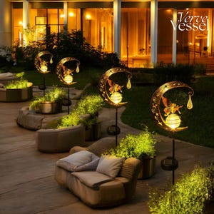Solar moon fairy garden light with crackle glass globe and warm LED glow, eco-friendly outdoor stake lamp powered by solar panel, durable iron frame with waterproof IP65 design, 800mAh rechargeable battery for 10–12 hours of light, height 84 cm and width 16 cm, perfect for garden pathways, patios, balconies, or yard decoration, whimsical moon fairy design adds charm to outdoor spaces, energy-saving solar garden decor, great gift for garden lovers, birthdays, or housewarmings.