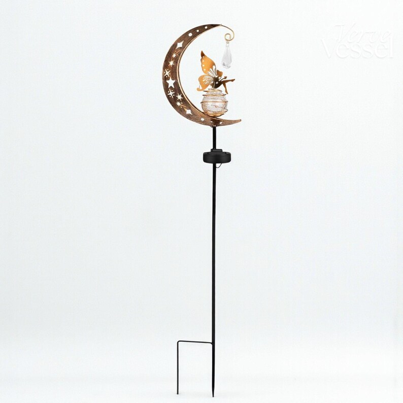 Solar moon fairy garden light with crackle glass globe and warm LED glow, eco-friendly outdoor stake lamp powered by solar panel, durable iron frame with waterproof IP65 design, 800mAh rechargeable battery for 10–12 hours of light, height 84 cm and width 16 cm, perfect for garden pathways, patios, balconies, or yard decoration, whimsical moon fairy design adds charm to outdoor spaces, energy-saving solar garden decor, great gift for garden lovers, birthdays, or housewarmings.