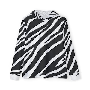 May include: A long-sleeved hoodie with a black and white zebra stripe pattern. The hoodie has a hood and white cuffs. The zebra print covers the entire garment, creating a bold and eye-catching design.