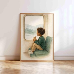 May include: Watercolor art print of a child sitting by a train window, looking out at a mountain landscape. The child wears a green sweater and tan pants. The artwork is framed in a light wood frame.